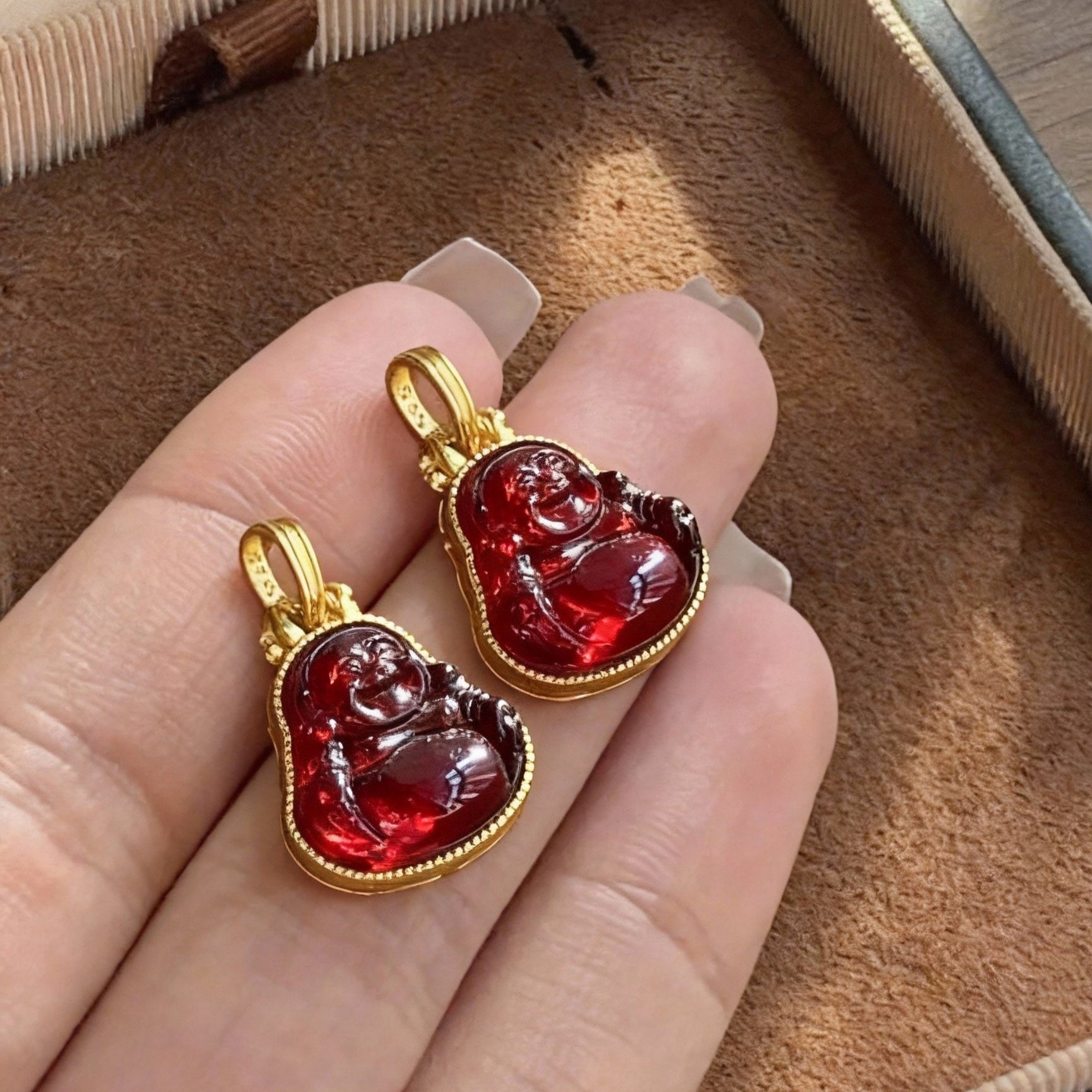 Close-up of blood amber Buddha pendant showing deep red color