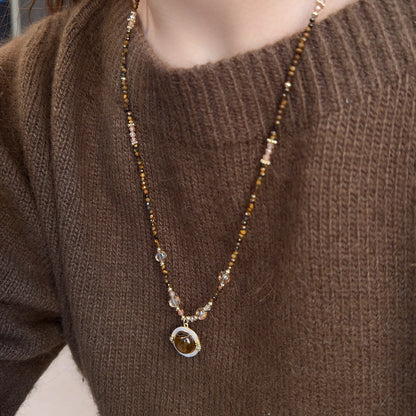 Long tiger eye necklace with decorative mother-of-pearl charm