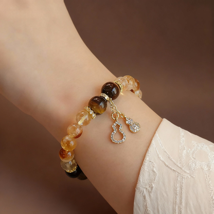Rutilated citrine and tiger eye stone bracelet with gourd charm
