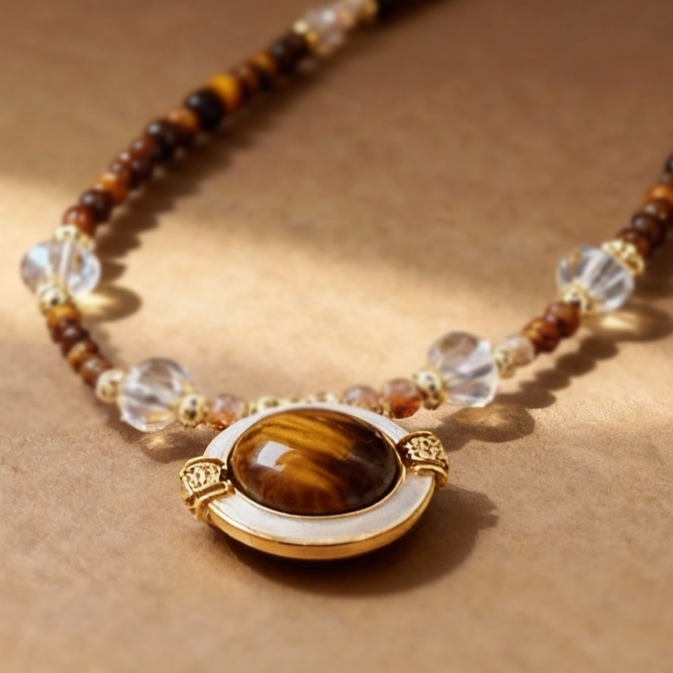 Close-up of tiger eye beads with iridescent mother-of-pearl pendant