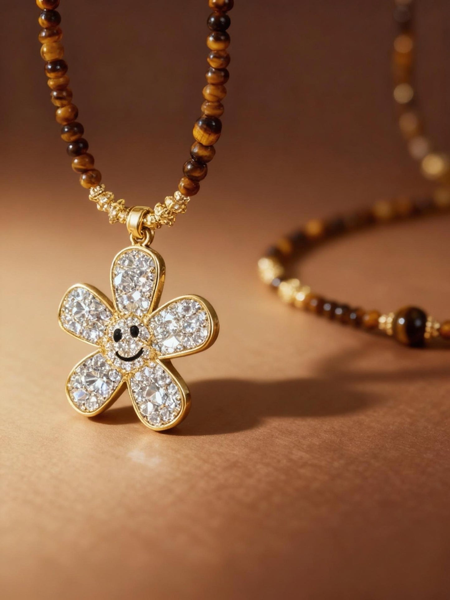 Close-up of tiger eye beads with sparkling zircon flower pendant