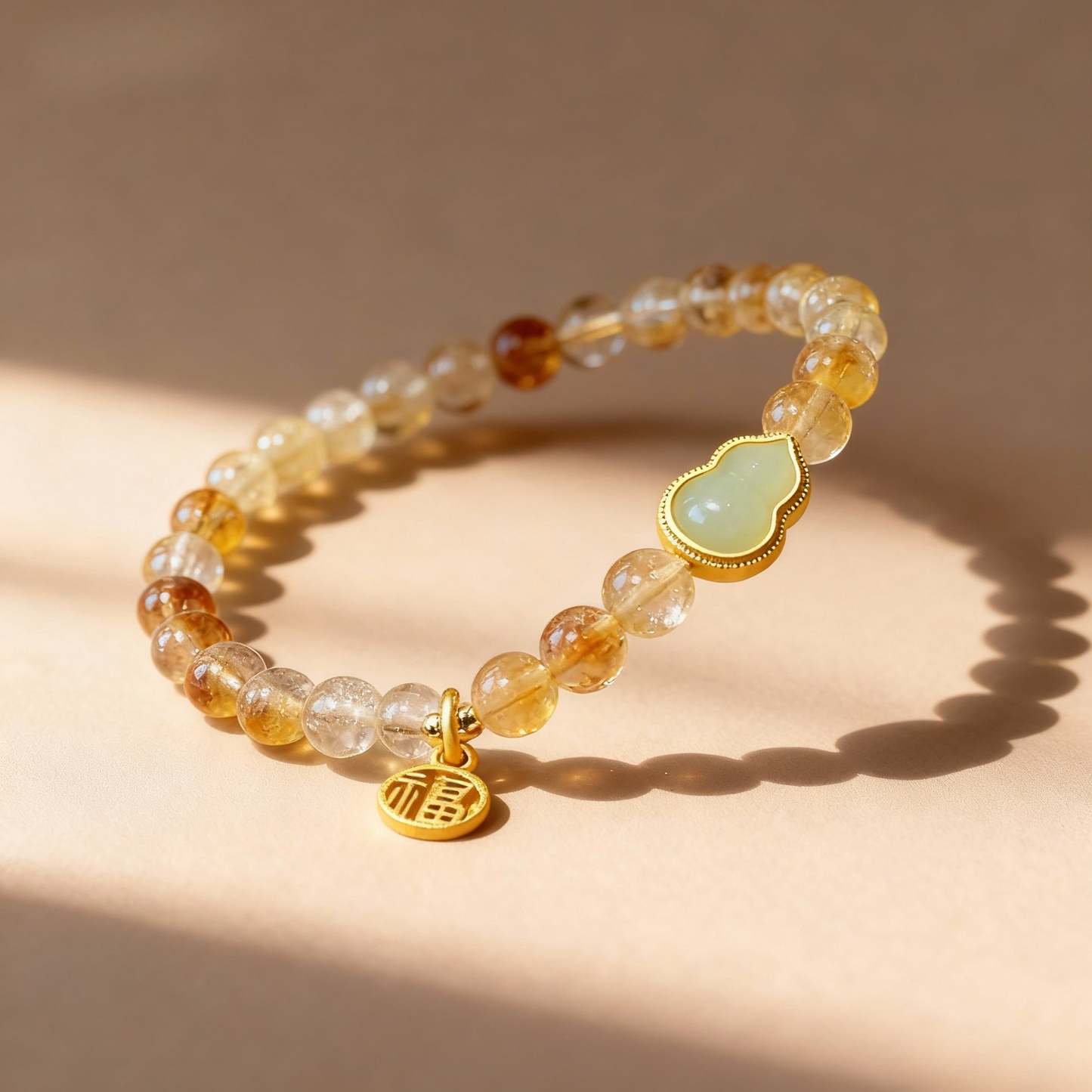 Detail of yellow citrine bracelet with jade calabash pendant