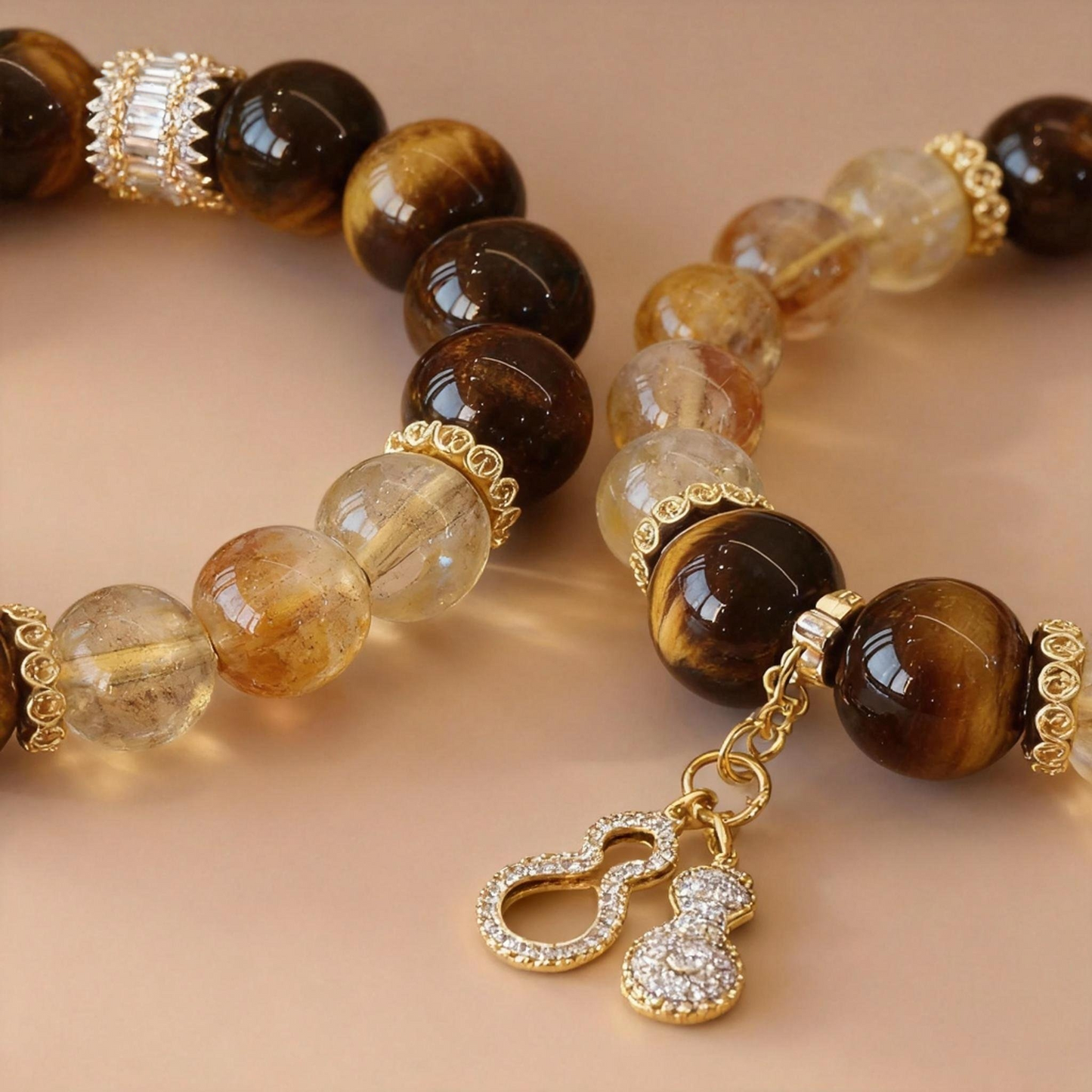 Detail of golden citrine and tiger eye bracelet with crystal gourd
