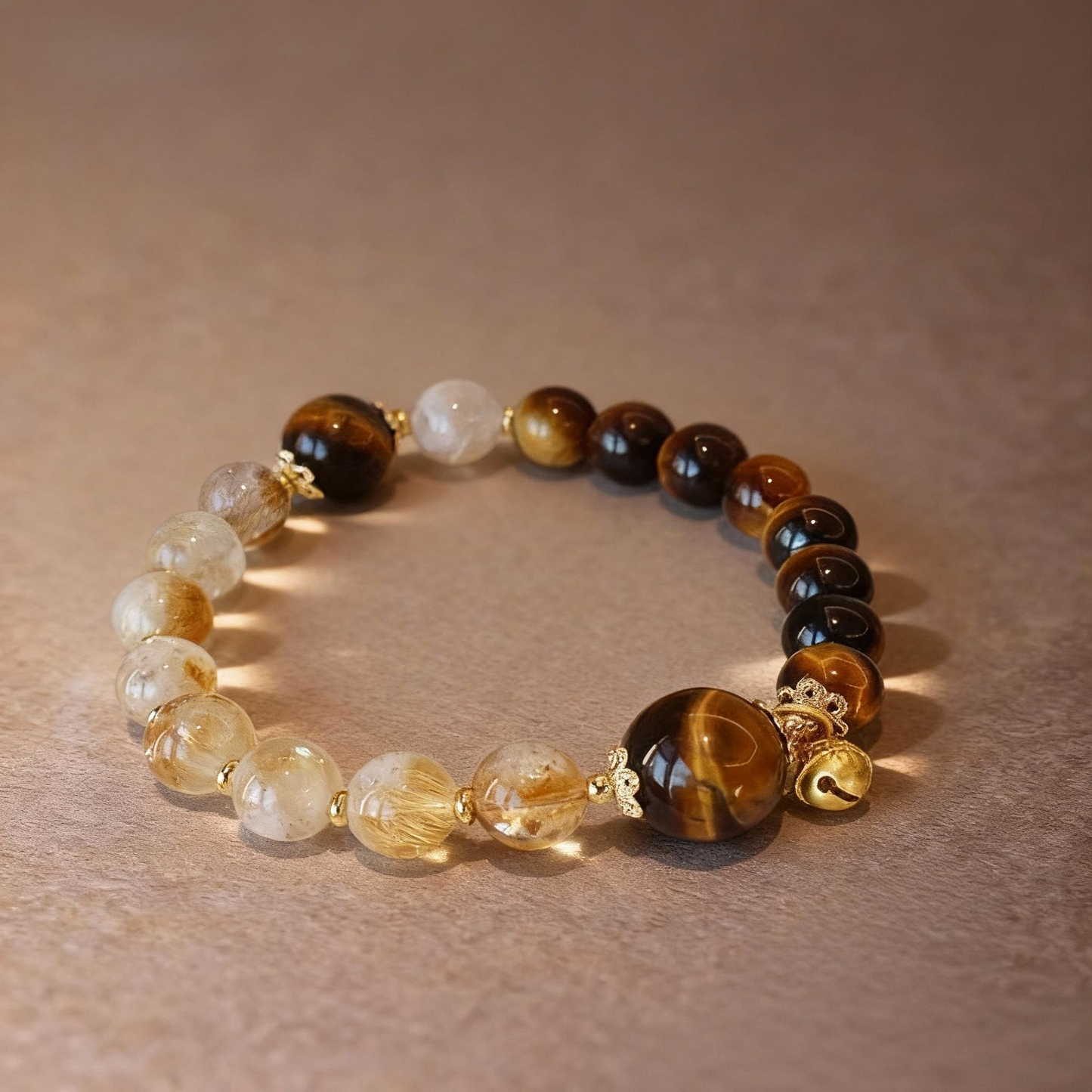 Close-up of rutilated citrine and tiger eye beads with gourd pendant