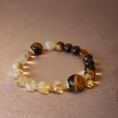 Close-up of rutilated citrine and tiger eye beads with gourd pendant