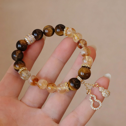 Natural rutilated citrine bracelet with tiger eye and gourd charm

