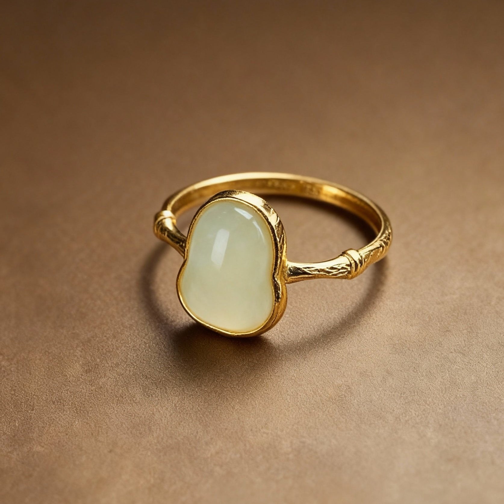 Detail of white jade ring band with natural color variations