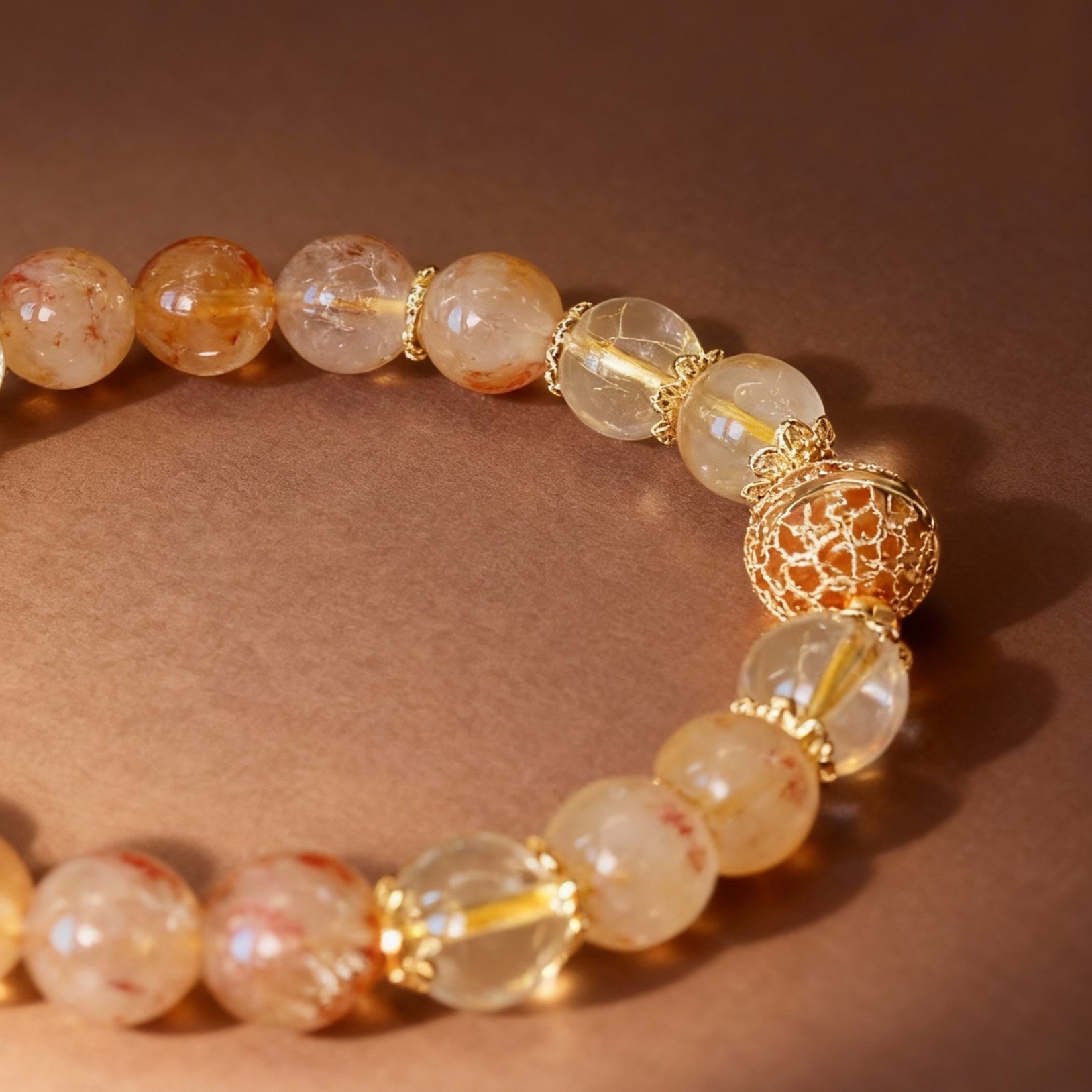 Golden rutilated quartz bracelet showing metal ball bead detail