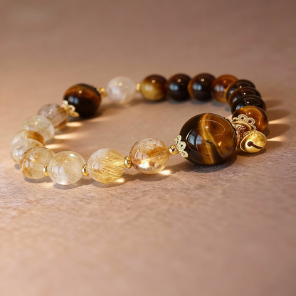 Detail of golden citrine and tiger eye bracelet with crystal gourd