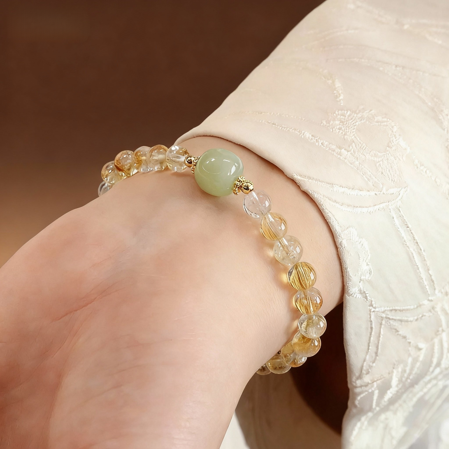 Close-up of citrine beads with green jade Buddha pendant