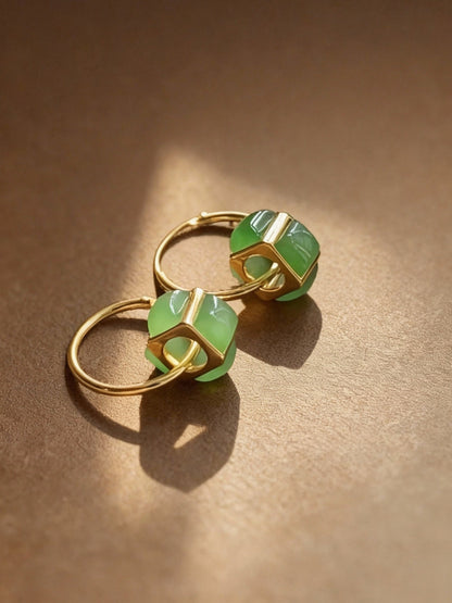 Close-up of jade jasper earrings showing natural green stone